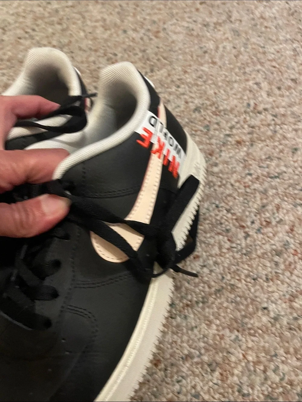 Nike Kids Black Sneakers with Cream Swoosh and Orange Accents